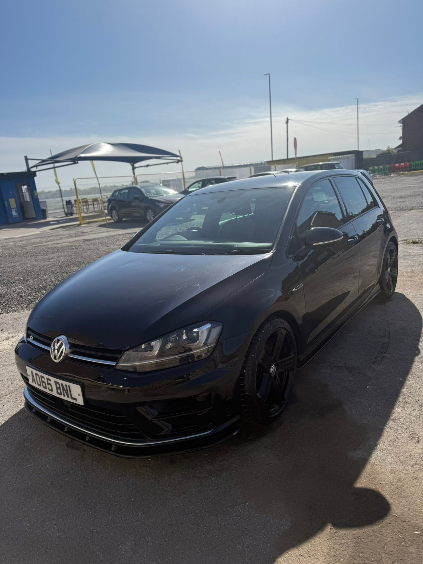 Black Volkswagen Golf R gleaming after a hand wash