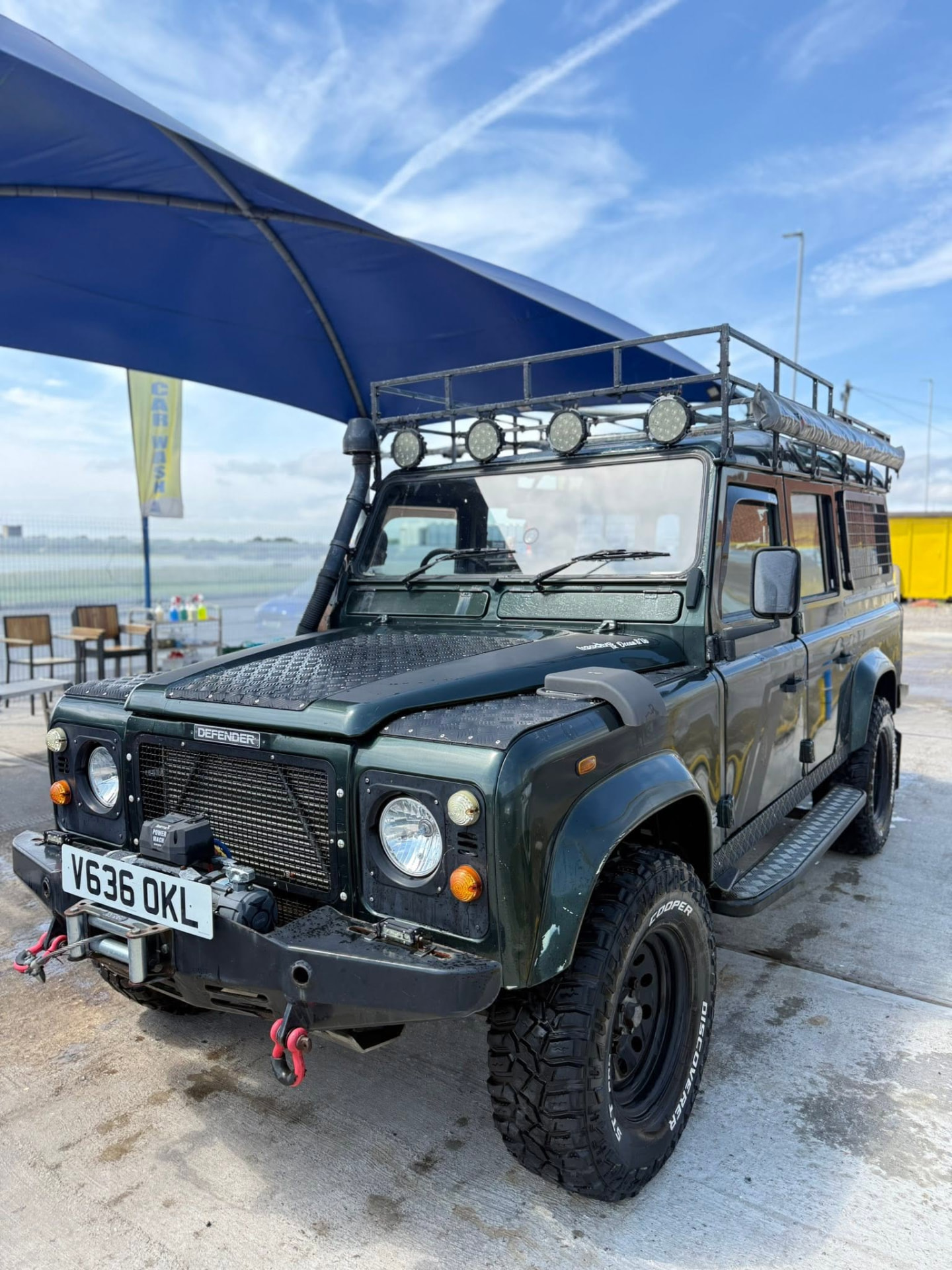 Land Rover Defender 110 cleaned under the blue canopy